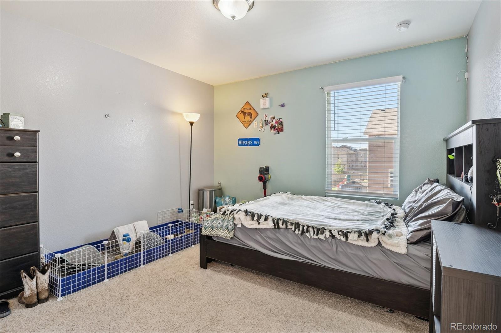 2328 Ruby Avenue Brighton, CO 80603 - Photo 17 of 21 a bedroom with a bed and a flat screen tv