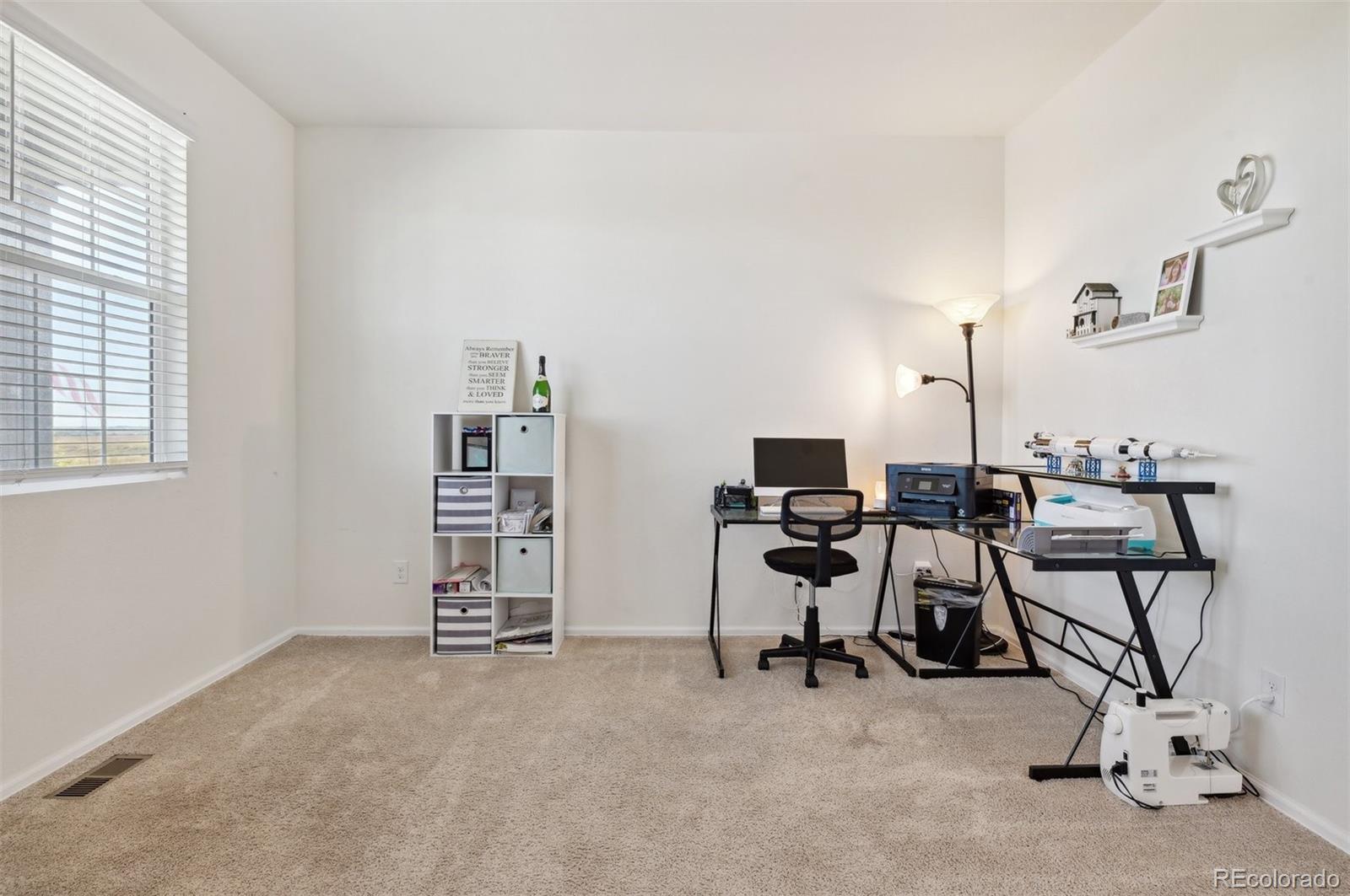 2328 Ruby Avenue Brighton, CO 80603 - Photo 4 of 21 a view of a workspace with furniture