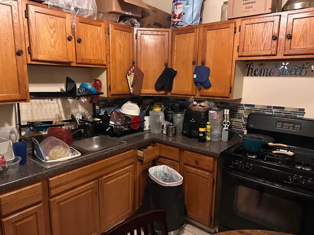a kitchen with blue cabinets and a stove