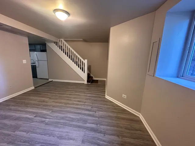a view of an entryway with wooden floor