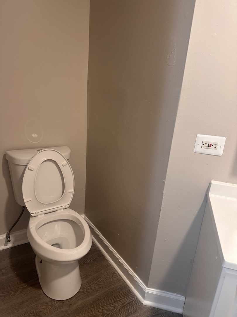 1842 South Drake Avenue Chicago, IL 60623 - Photo 26 of 47 a white toilet sitting next to a shower