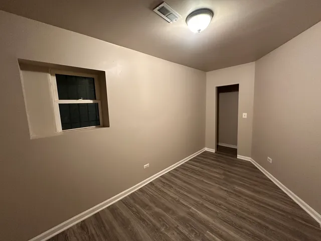 a view of a room with wooden floor