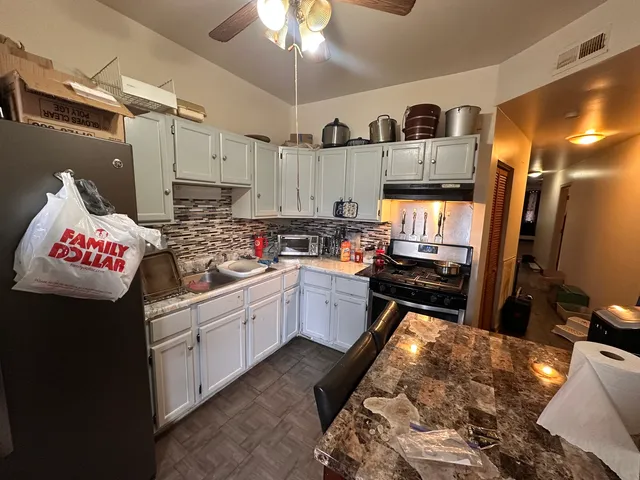a kitchen with a sink appliances and cabinets