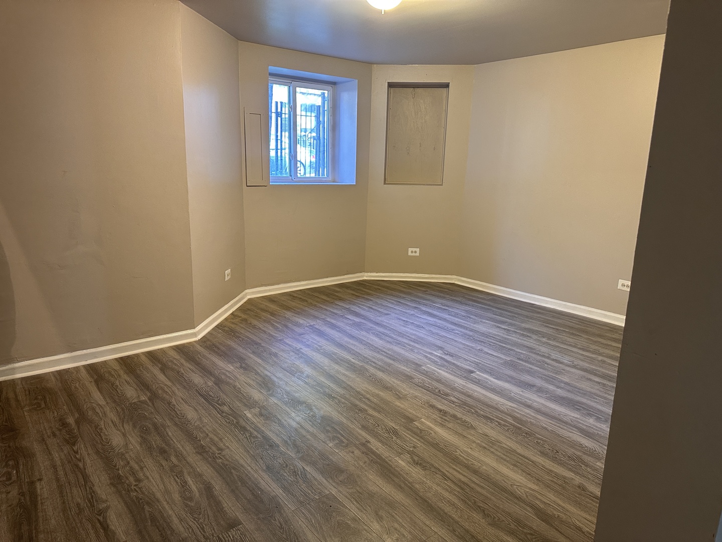 1842 South Drake Avenue Chicago, IL 60623 - Photo 37 of 47 a view of an empty room with wooden floor and a window