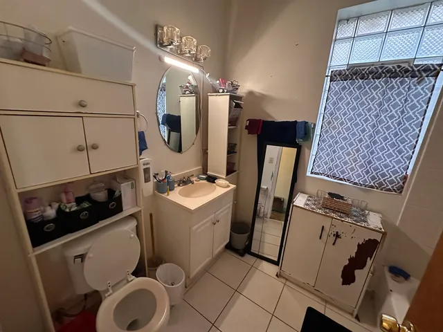 a bathroom with a sink mirror vanity and toilet