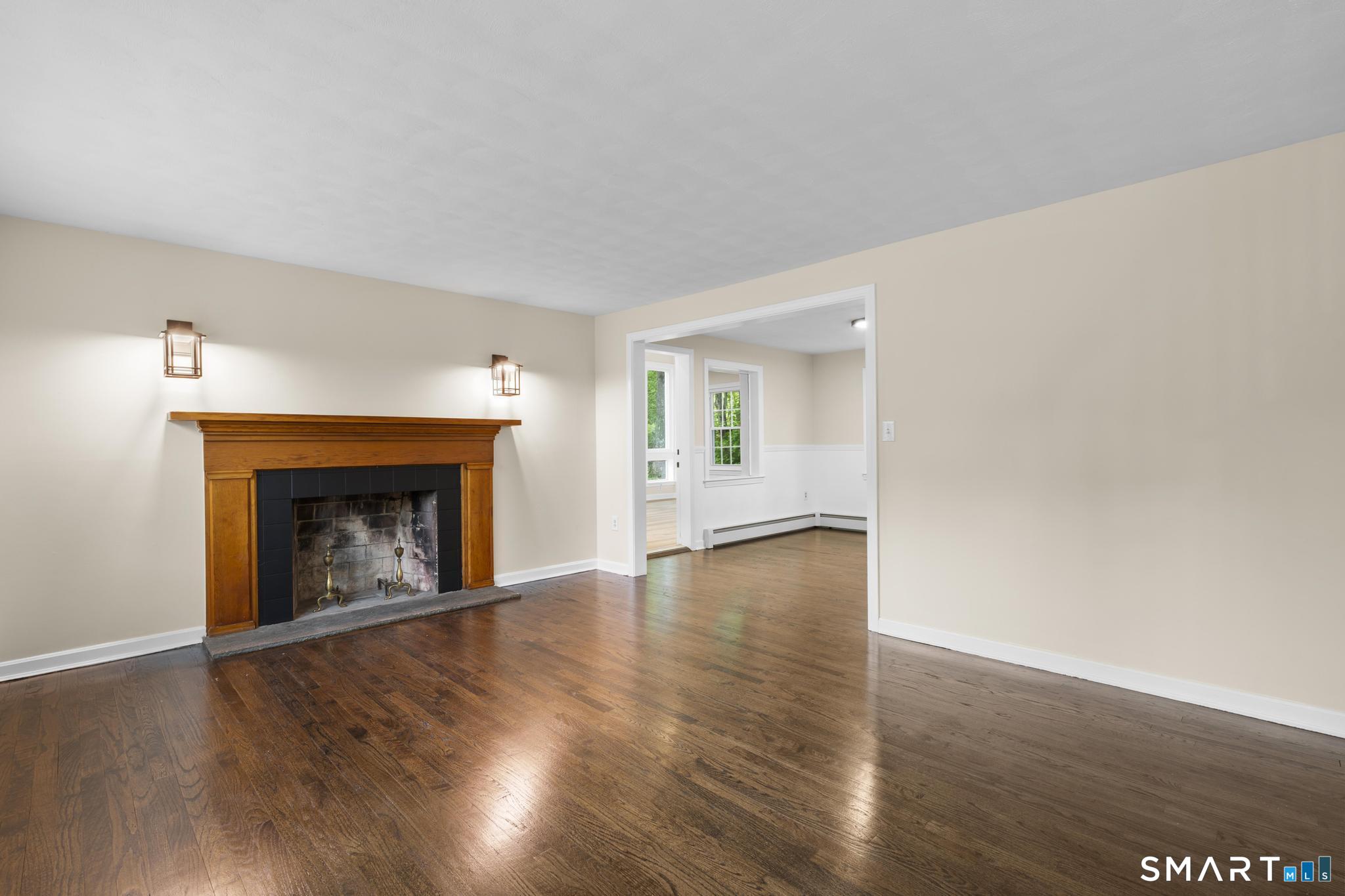 7 Sycamore Terrace Windham, CT 06280 - Photo 3 of 40 a view of an empty room with wooden floor fireplace and a window