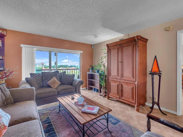 a living room with furniture a rug and a window