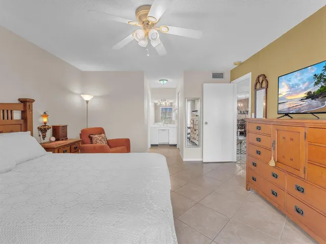 a large bedroom with a bed and a chandelier