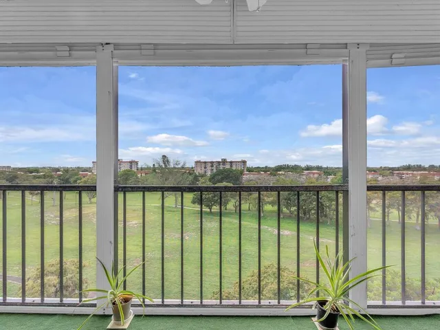 a view of a balcony with a floor to ceiling windows with wooden floor