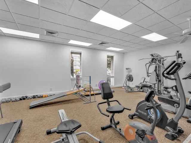 a room with gym equipment and a table
