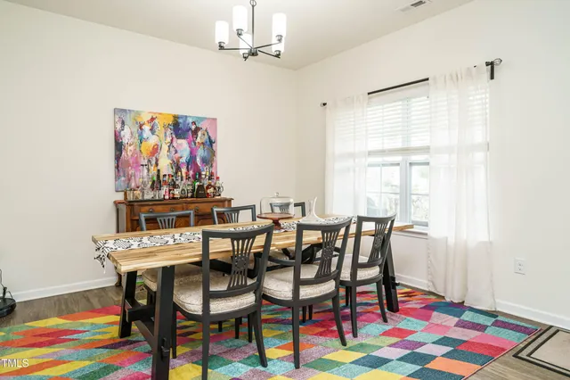a view of a dining room with furniture and rug