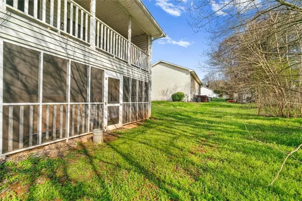 a view of a backyard with wooden fence