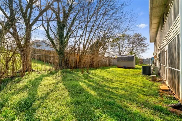a view of a house with backyard and tree