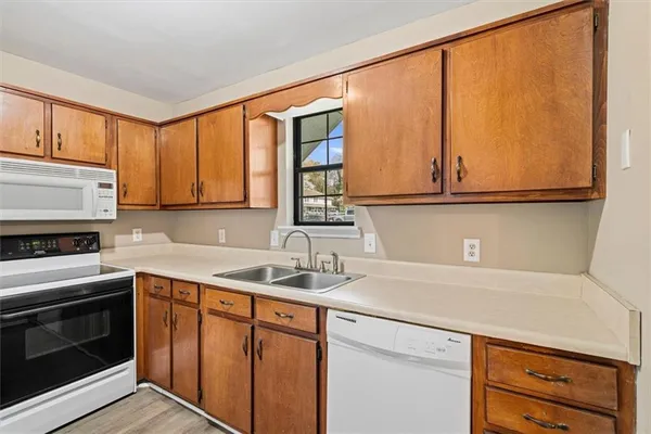 a kitchen with appliances cabinets and a sink