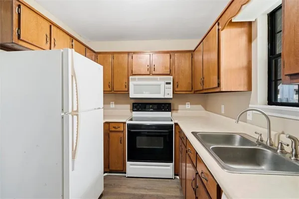a kitchen with stainless steel appliances granite countertop a refrigerator and a sink