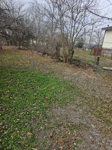 a view of a yard with a tree