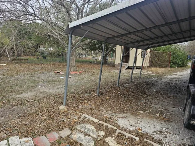 a backyard of a house with a table and chairs