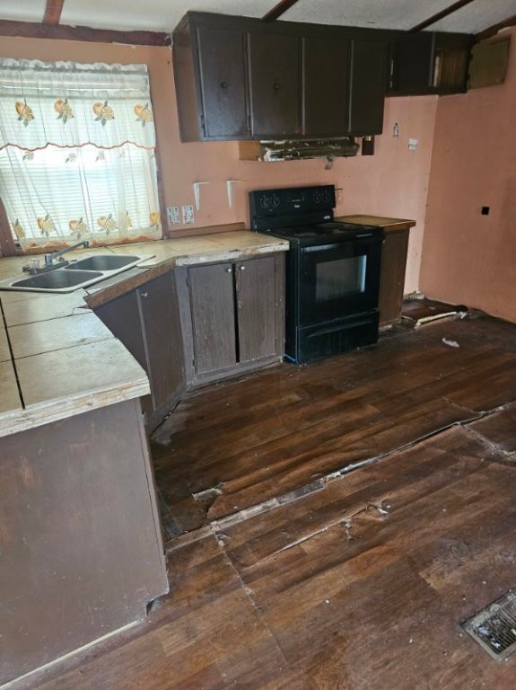 408 Greenfield Road Kyle, TX 78640 - Photo 4 of 19 a kitchen with kitchen island a stove and a sink