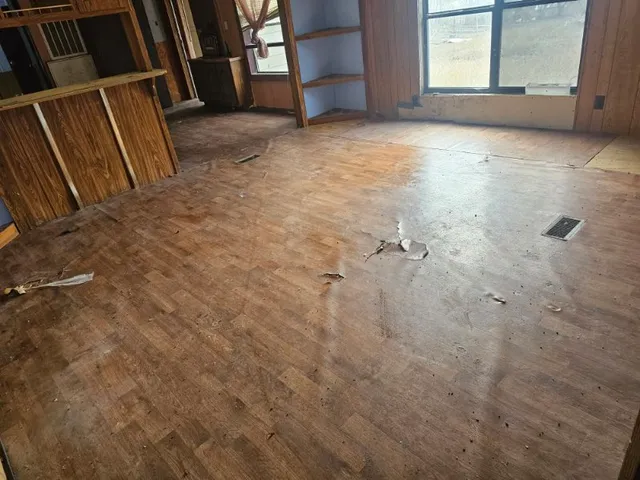 a view of an empty room with a fireplace