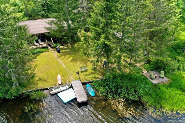 an aerial view of a house with swimming pool and garden