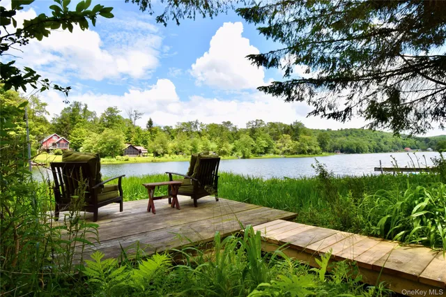 a view of a garden with plants and a lake view in the back