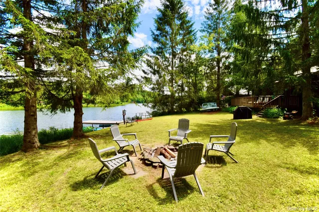 a view of swimming pool with table and chairs