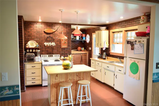 a kitchen with stainless steel appliances kitchen island wooden cabinets and stove