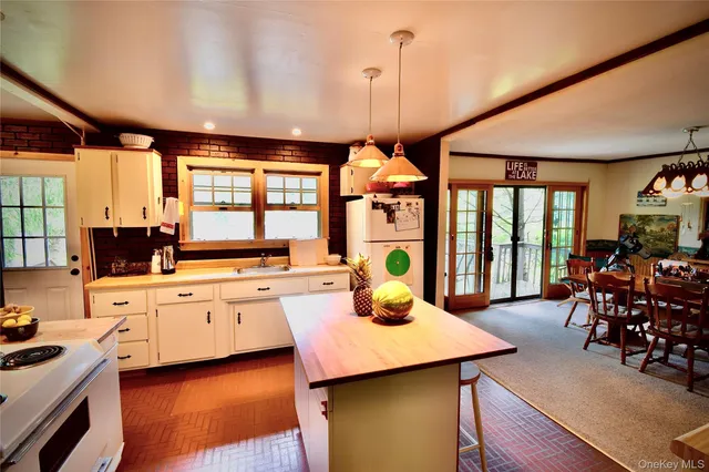 a kitchen with stainless steel appliances granite countertop sink stove and wooden floor