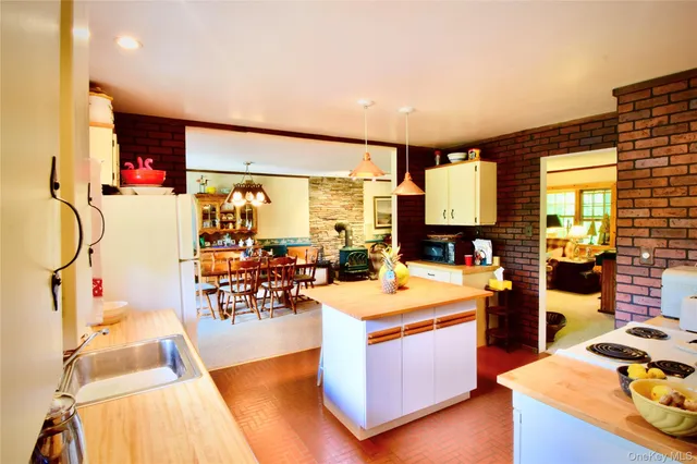 a room with stainless steel appliances a stove and wooden floor