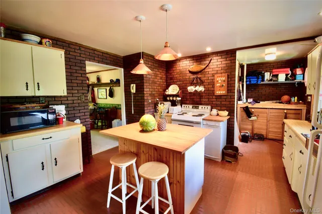 a kitchen with a sink a counter space and wooden floor