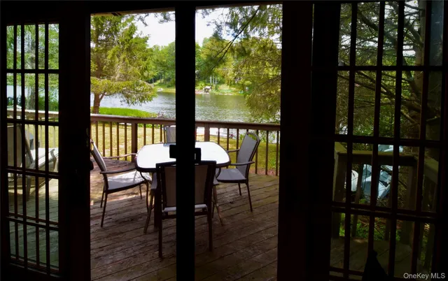 a view of balcony with wooden floor and outdoor seating