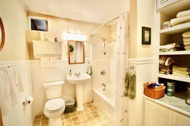 a view of a house with wooden fence