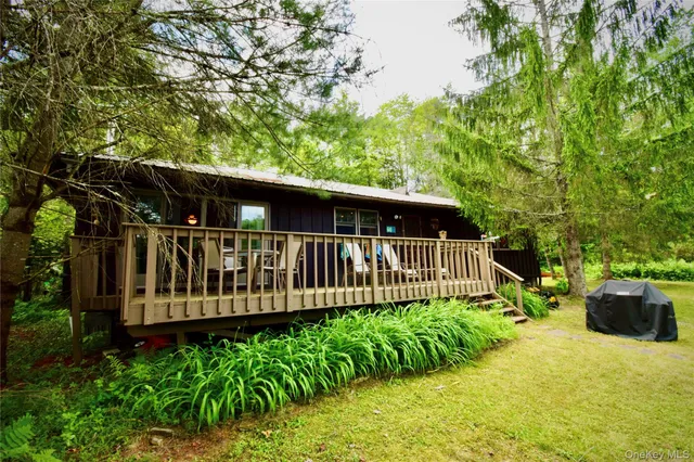 a view of a lake with a table and chairs