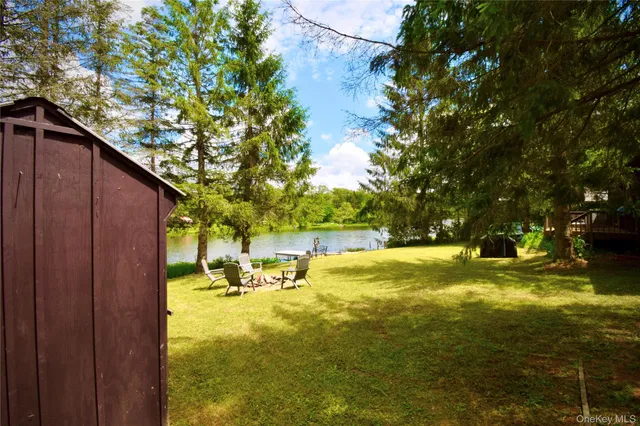 a swimming pool with yard and outdoor seating
