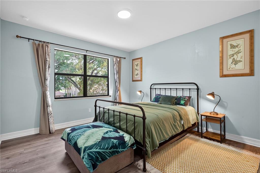 7845 Bristol Circle Naples, FL 34120 - Photo 20 of 31 a bedroom with a bed and a window