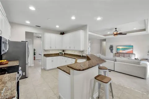 a kitchen with stainless steel appliances granite countertop a sink and a stove