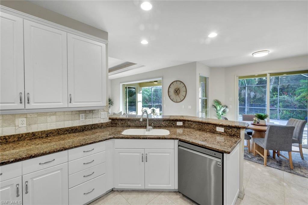 7830 Twin Eagle Lane Fort Myers, FL 33912 - Photo 12 of 31 a kitchen that has a sink and a stove in it