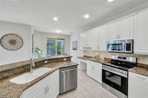 a dining room with furniture and potted plants