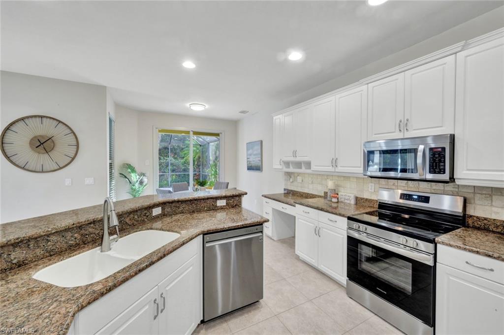 7830 Twin Eagle Lane Fort Myers, FL 33912 - Photo 13 of 31 a kitchen with stainless steel appliances granite countertop a sink and a stove