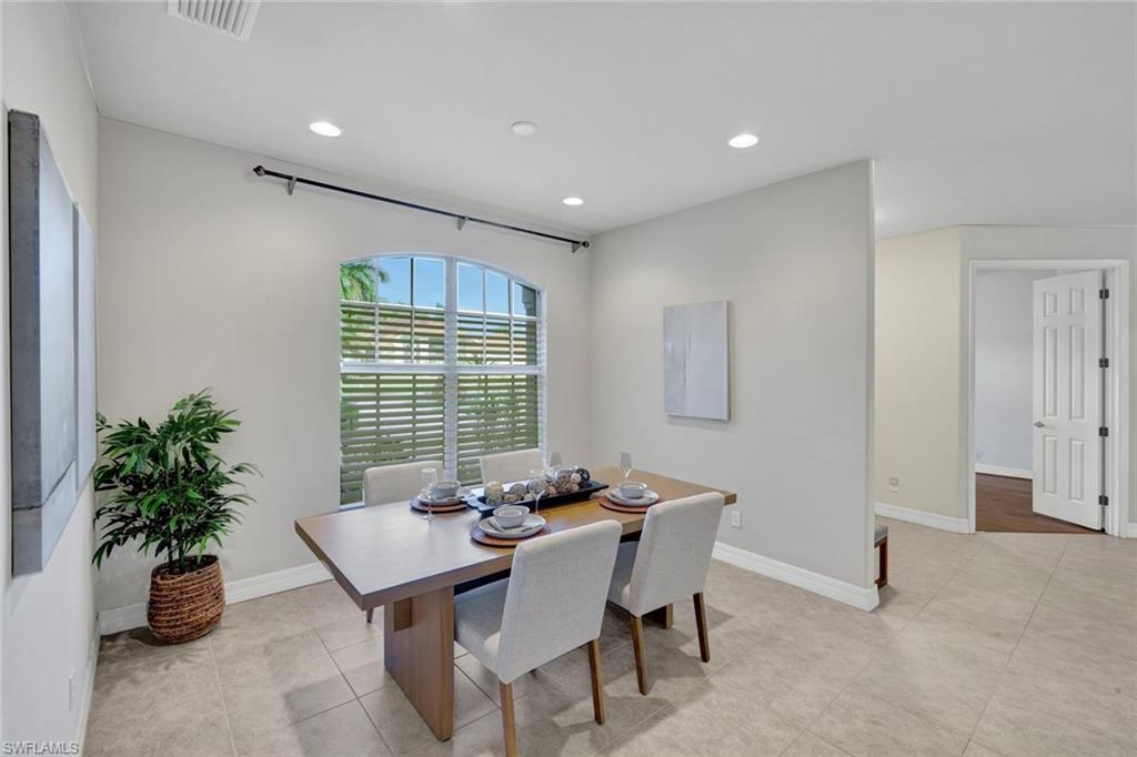 7830 Twin Eagle Lane Fort Myers, FL 33912 - Photo 15 of 31 a dining room with furniture and potted plants
