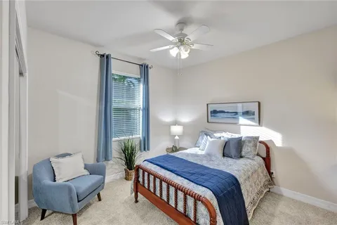 a spacious bedroom with a bed and a chandelier
