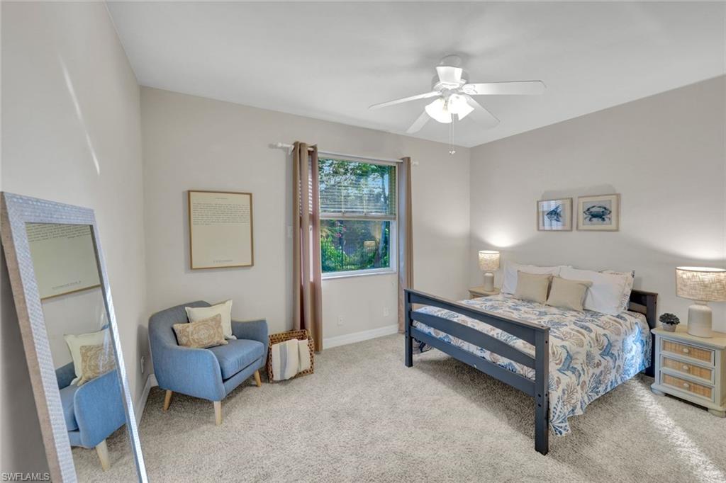 7830 Twin Eagle Lane Fort Myers, FL 33912 - Photo 23 of 31 a spacious bedroom with a bed and a chandelier