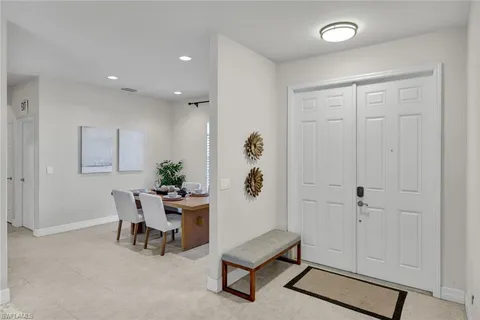 a living room with furniture a large window and a chandelier