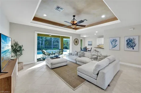 a living room with furniture and a chandelier