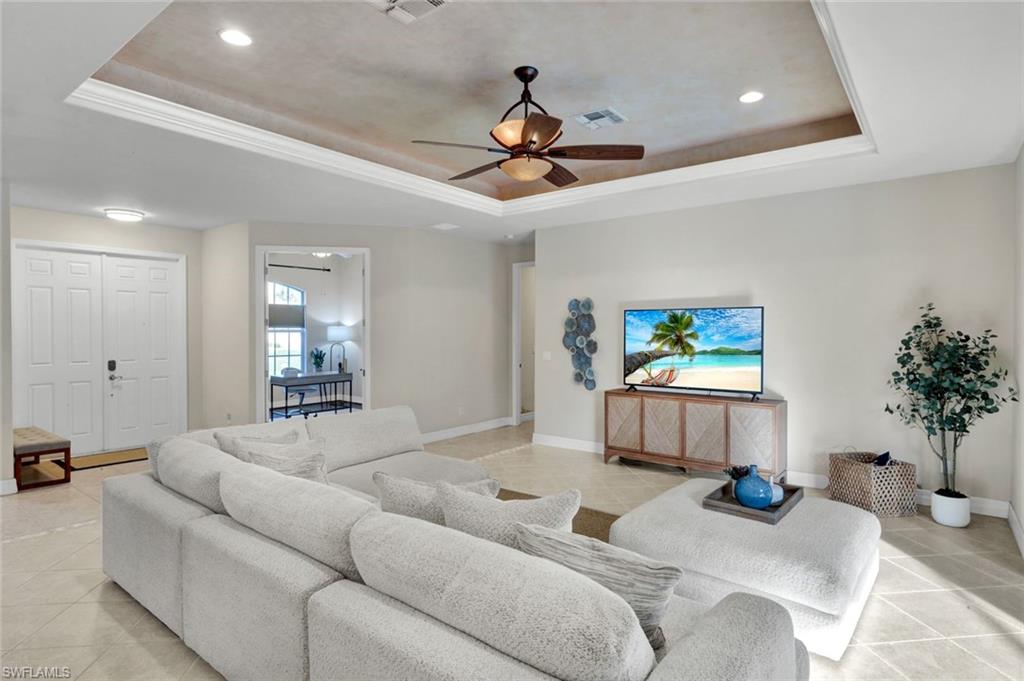 7830 Twin Eagle Lane Fort Myers, FL 33912 - Photo 8 of 31 a living room with furniture and a chandelier