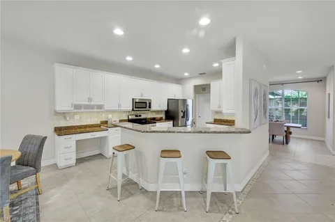 a kitchen that has a sink and a stove in it
