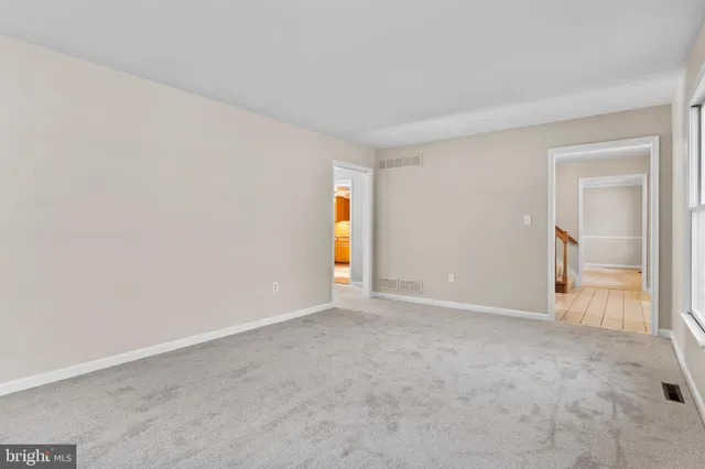 a view of an empty room and a window