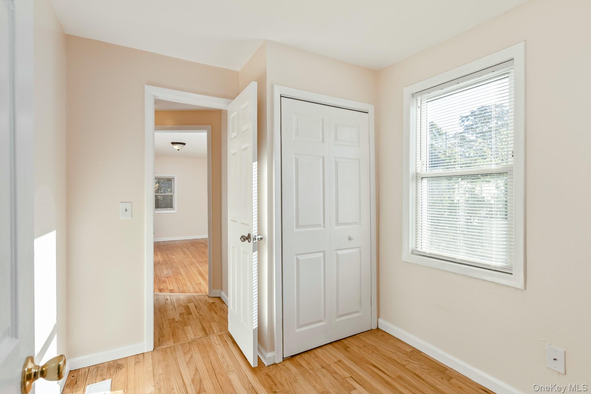 860 Flanders Road Flanders, NY 11901 - Photo 20 of 31 a view of a hallway with wooden floor and closet area