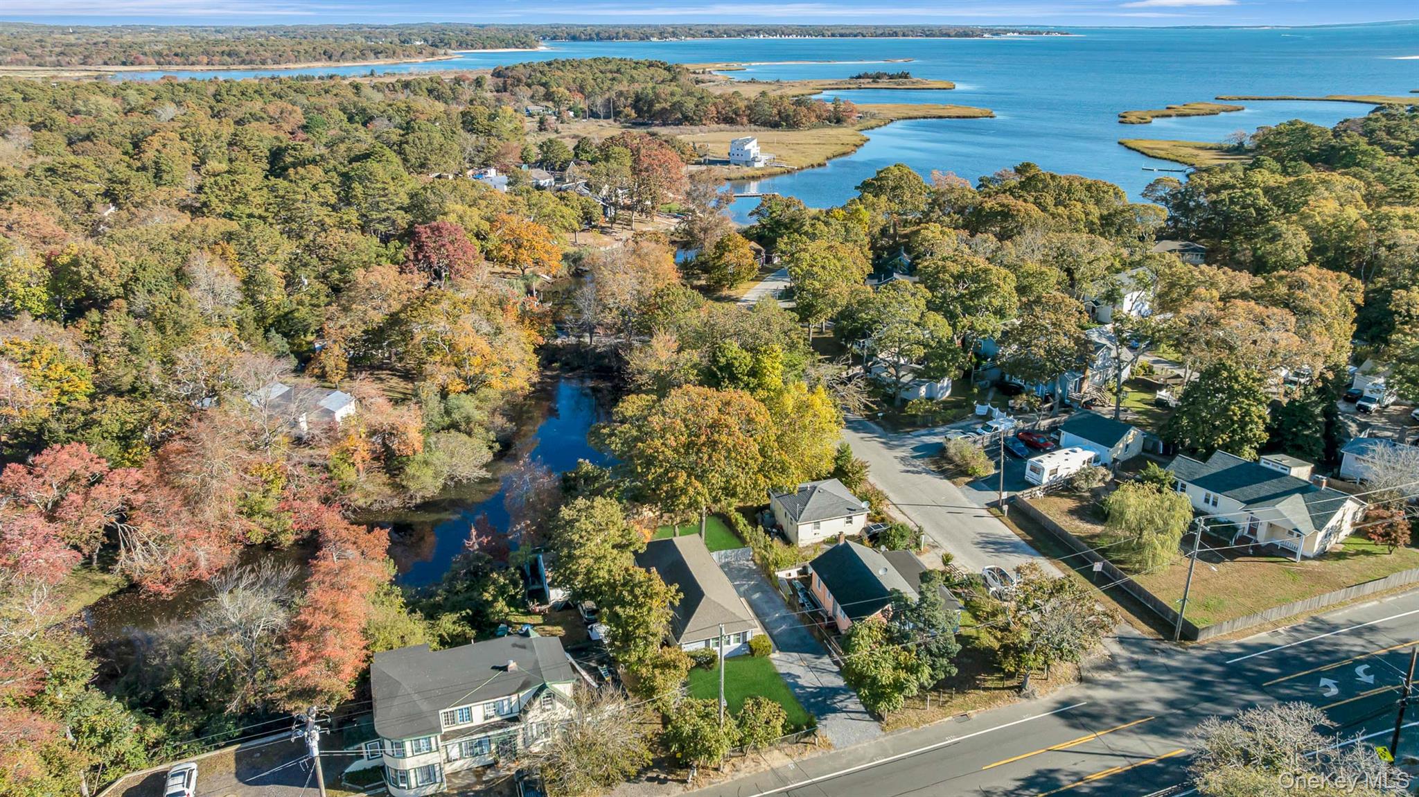 860 Flanders Road Flanders, NY 11901 - Photo 2 of 31 Aerial view of property's location featuring nearby suburban area and a large body of water