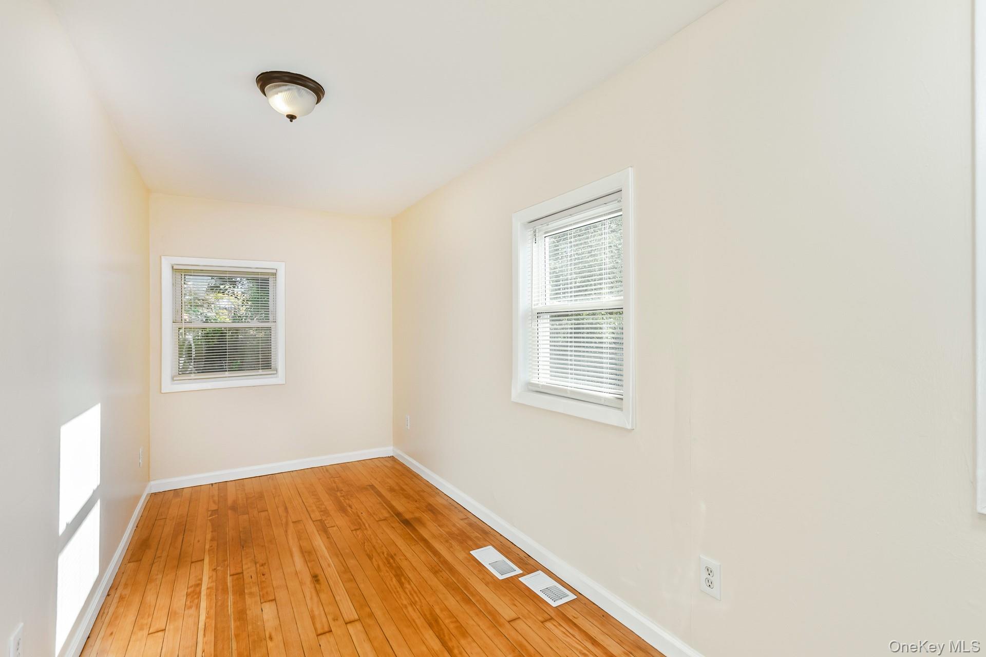 860 Flanders Road Flanders, NY 11901 - Photo 21 of 31 a view of an empty room with wooden floor and a window